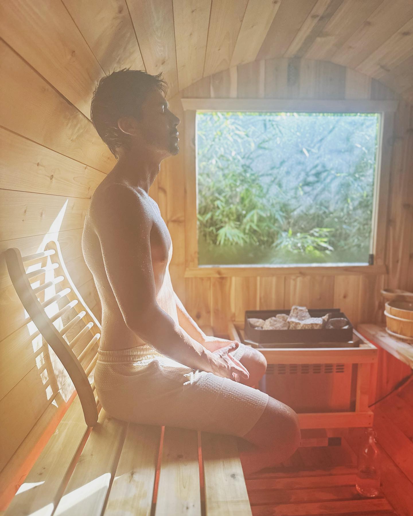 A guest relaxing inside the cedar sauna