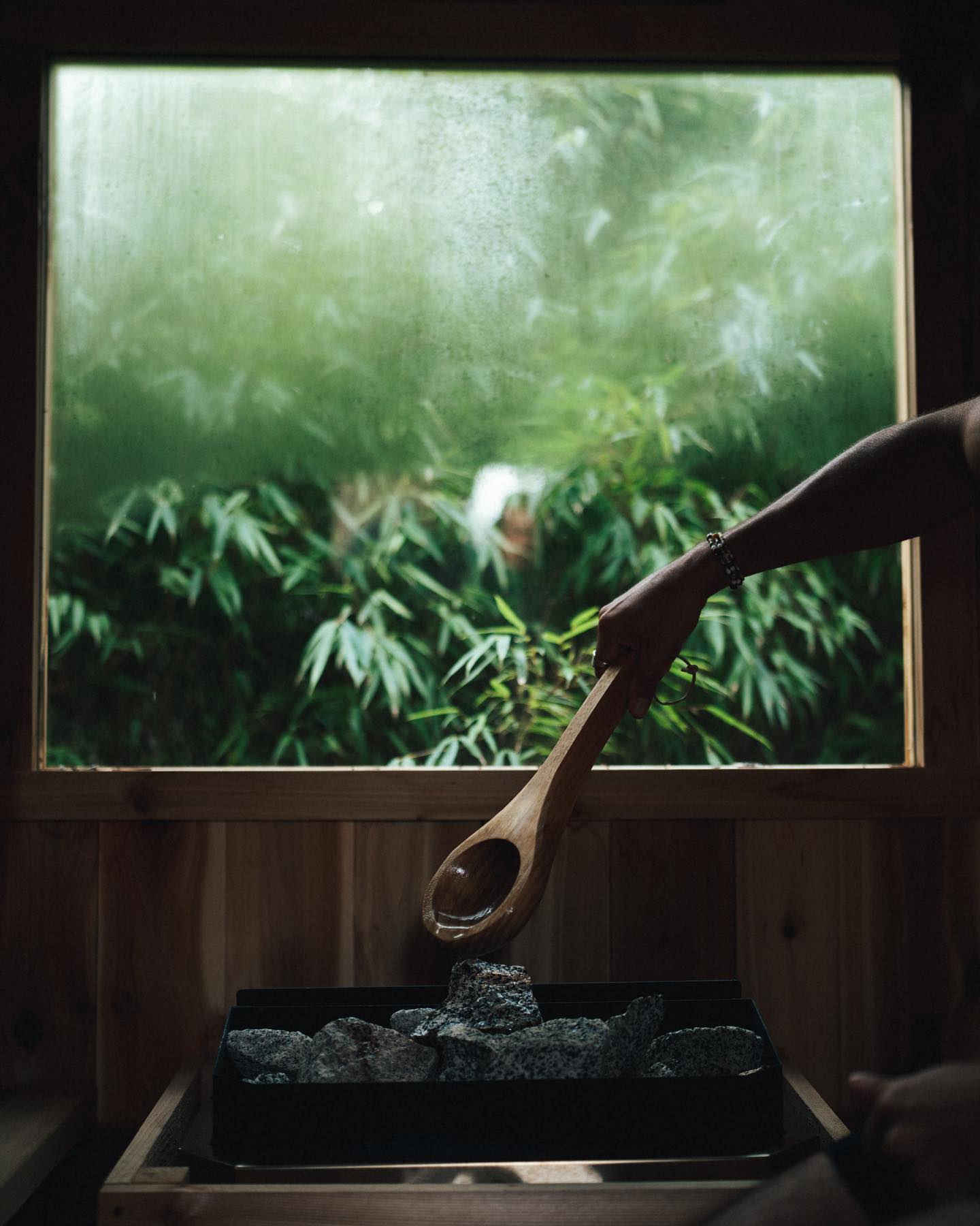 Water being poured over sauna stones